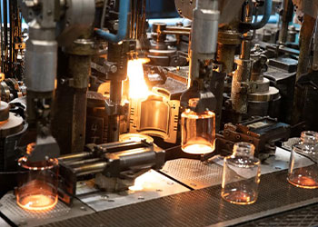Clear flint glass bottle in production at a cosmetic glass bottle factory